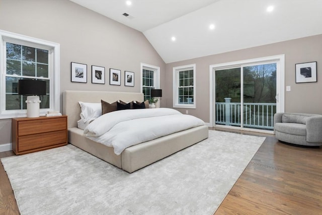 bedroom featuring access to outside, wood finished floors, recessed lighting, vaulted ceiling, and baseboards