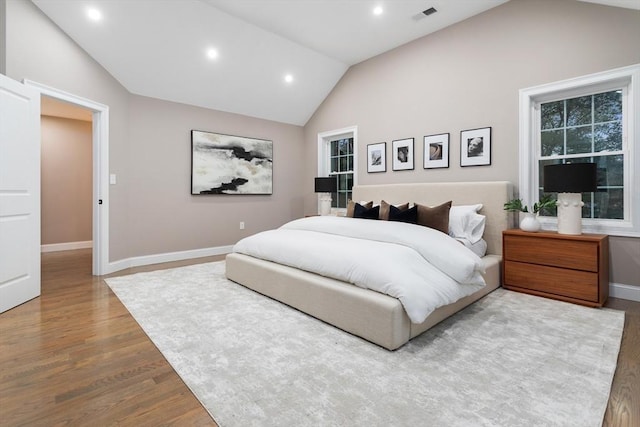 bedroom featuring lofted ceiling, wood finished floors, recessed lighting, and baseboards