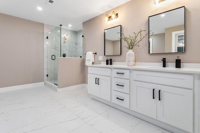 bathroom with marble look tile flooring, recessed lighting, a marble finish shower, baseboards, and double vanity