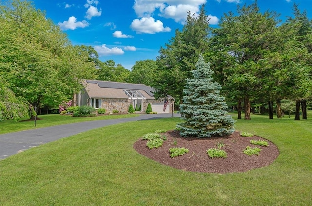 3 Riverside Dr, Mattapoisett, MA 02739 - mid-century inspired home featuring solar panels, a front lawn, stone siding, and driveway