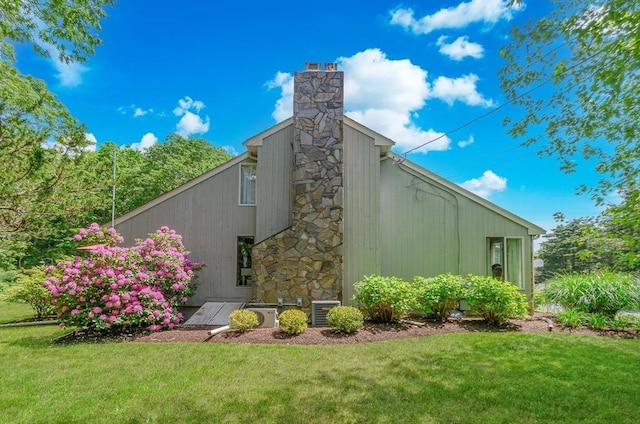 3 Riverside Dr, Mattapoisett, MA 02739 - view of home's exterior featuring a yard and a chimney