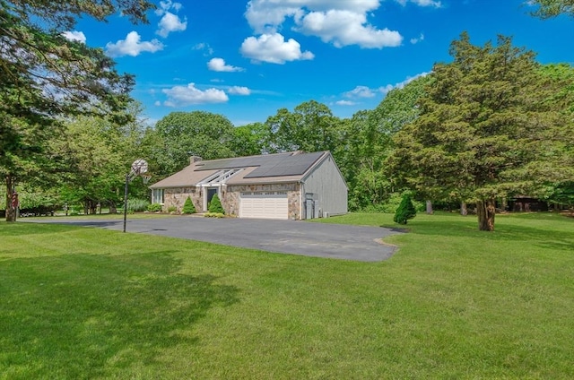3 Riverside Dr, Mattapoisett, MA 02739 - view of front facade with solar panels, a front yard, asphalt driveway, and a chimney