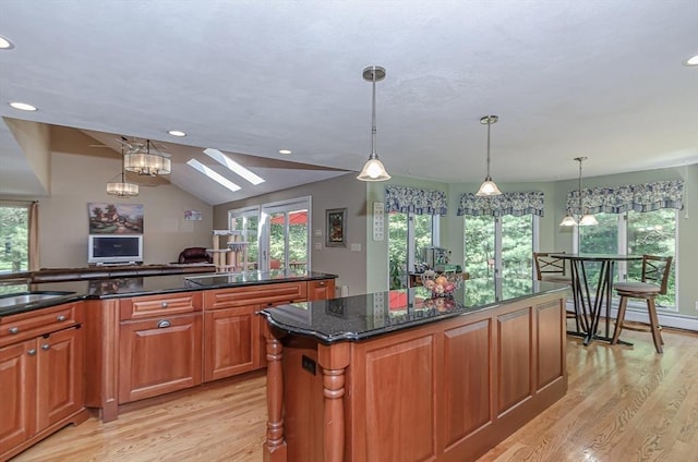 3 Riverside Dr, Mattapoisett, MA 02739 - kitchen featuring light wood-style flooring, a center island, a skylight, healthy amount of natural light, and recessed lighting