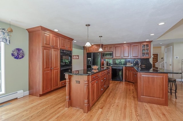 3 Riverside Dr, Mattapoisett, MA 02739 - kitchen featuring black appliances, a breakfast bar, light wood-style flooring, a peninsula, and recessed lighting