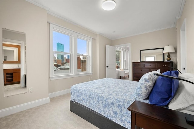 bedroom featuring light carpet, crown molding, and ensuite bathroom