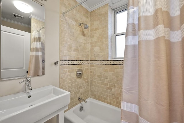 bathroom featuring plenty of natural light, shower / bathtub combination with curtain, ornamental molding, and sink