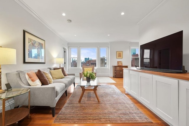 living room with light wood-type flooring, crown molding, and recessed lighting