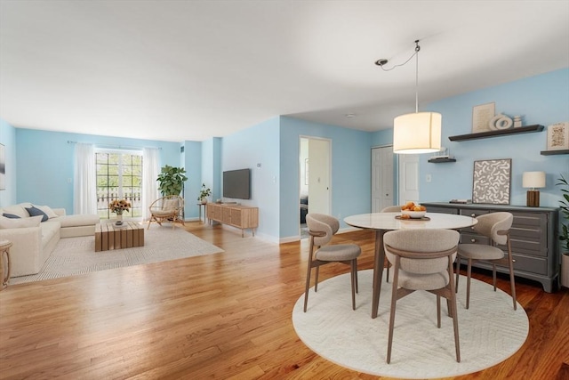 160 Commandants Way Unit 104, Chelsea, MA 02150 - dining space featuring wood finished floors and baseboards