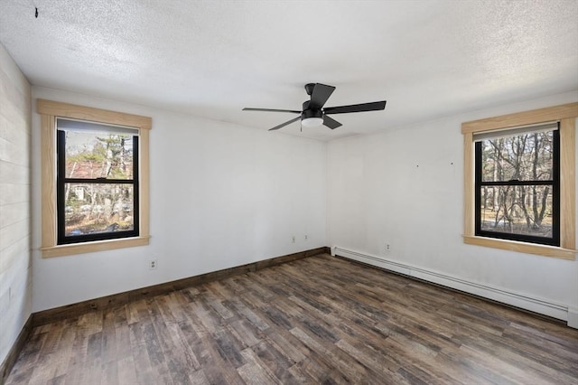 unfurnished room with baseboard heating, ceiling fan, dark hardwood / wood-style flooring, and a textured ceiling