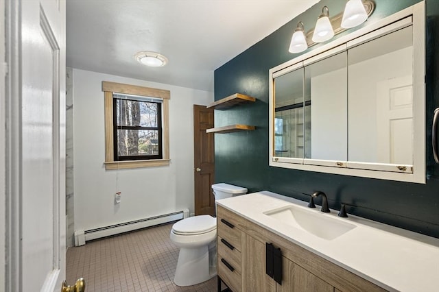 bathroom with vanity, tile patterned floors, toilet, and baseboard heating