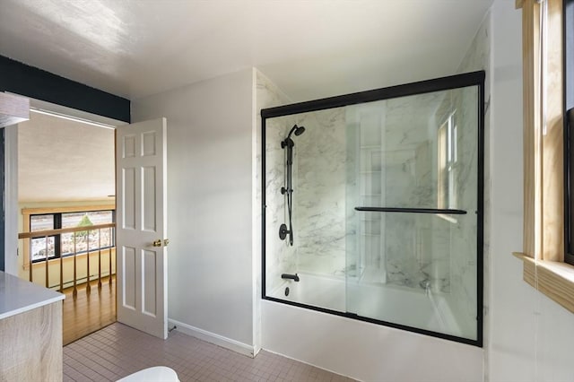 bathroom with toilet, bath / shower combo with glass door, and tile patterned flooring