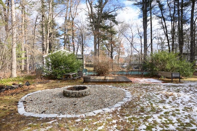 view of yard with a deck and an outdoor fire pit