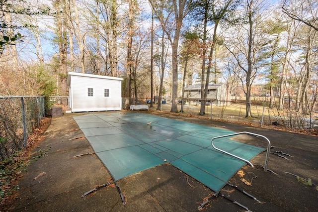 view of swimming pool featuring an outbuilding