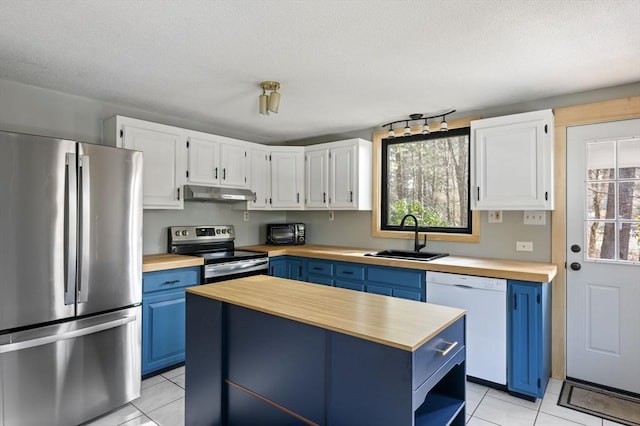 kitchen featuring blue cabinetry, sink, white cabinetry, a kitchen island, and stainless steel appliances