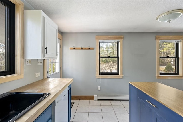 kitchen featuring baseboard heating, blue cabinets, dishwasher, and white cabinets