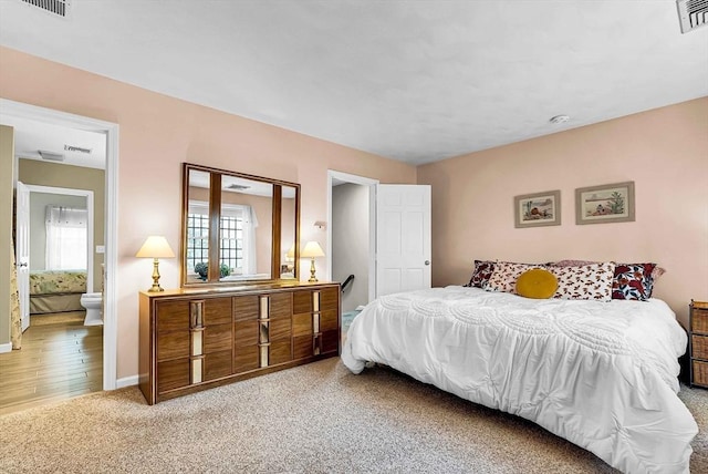 bedroom with light colored carpet, visible vents, and baseboards