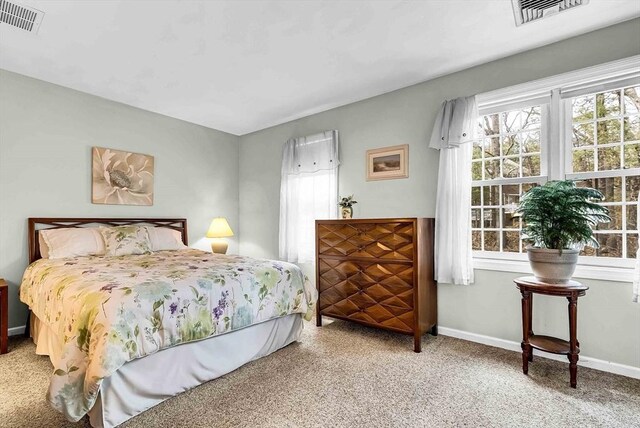 bedroom with carpet, baseboards, and visible vents