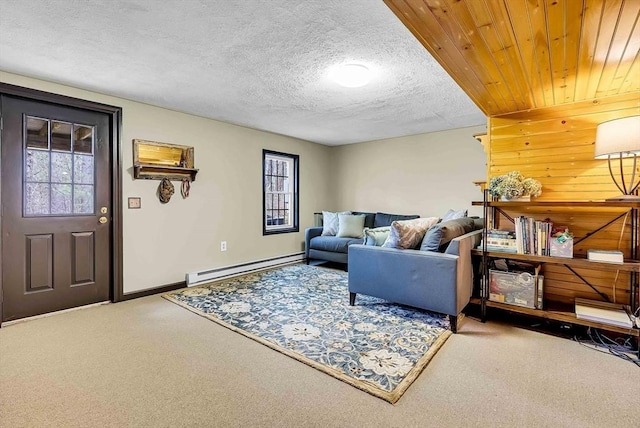 living area featuring a baseboard radiator, carpet, baseboards, and a textured ceiling