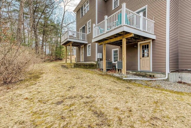 view of home's exterior with central air condition unit and a wooden deck