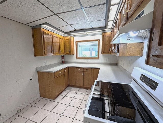 22 Newton Ave, Tewksbury, MA 01876 - kitchen with electric stove, extractor fan, brown cabinets, light countertops, and a paneled ceiling