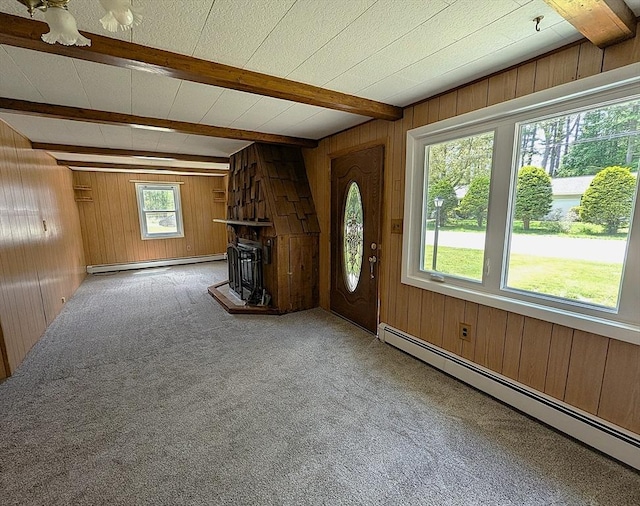 22 Newton Ave, Tewksbury, MA 01876 - unfurnished living room with a baseboard heating unit, a baseboard radiator, beamed ceiling, wooden walls, and carpet flooring