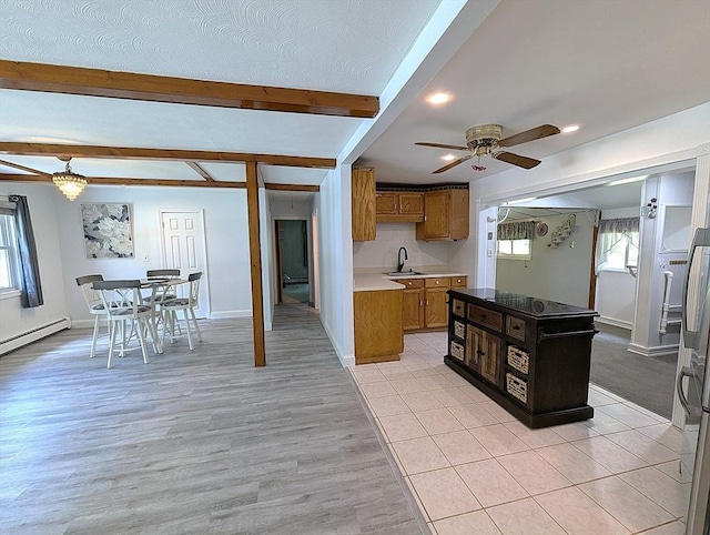 22 Newton Ave, Tewksbury, MA 01876 - kitchen featuring beamed ceiling, a ceiling fan, brown cabinets, light wood-style flooring, and recessed lighting