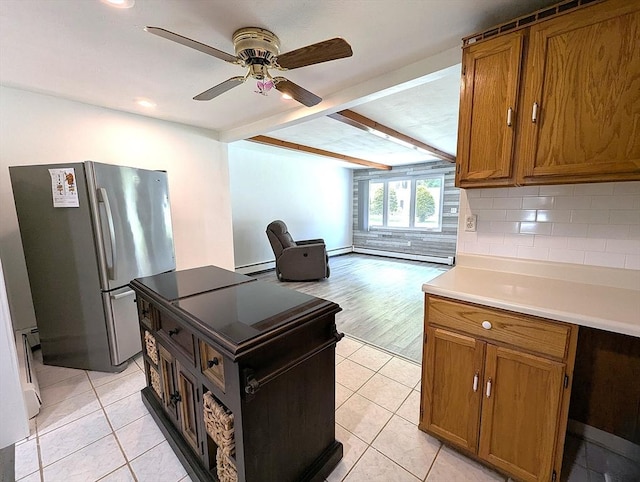 22 Newton Ave, Tewksbury, MA 01876 - kitchen featuring freestanding refrigerator, brown cabinetry, light tile patterned floors, beamed ceiling, and recessed lighting