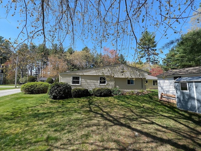 22 Newton Ave, Tewksbury, MA 01876 - view of property exterior featuring a lawn and an outbuilding