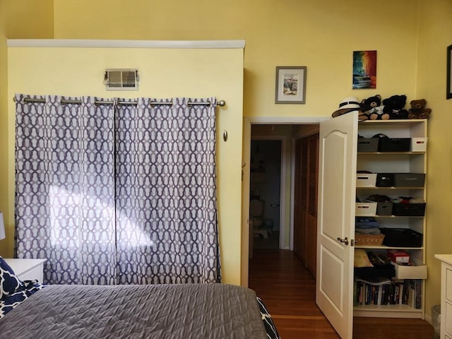 bedroom with dark wood-type flooring