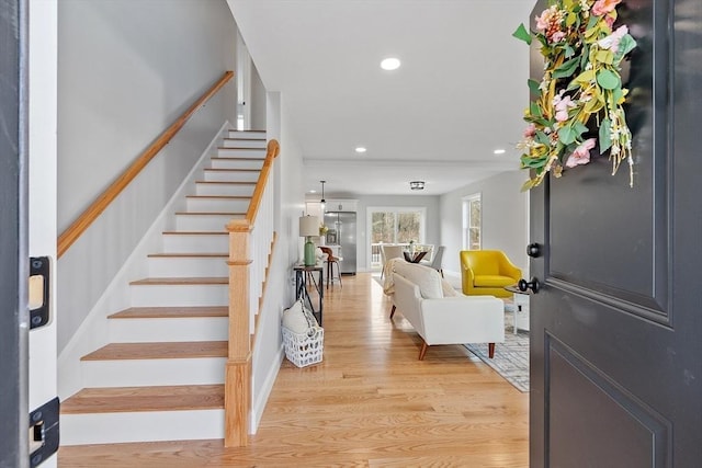 foyer with recessed lighting, stairs, and light wood-style floors