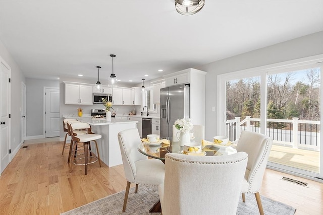 dining area with recessed lighting, visible vents, light wood finished floors, and baseboards