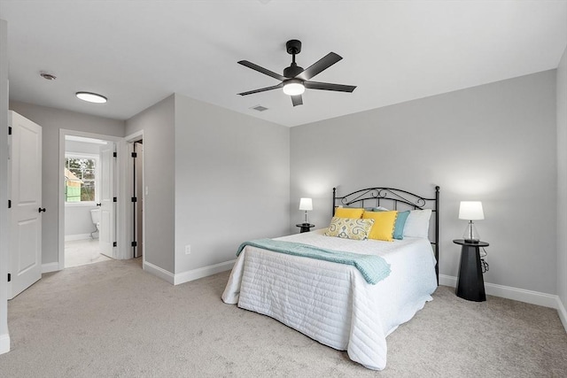carpeted bedroom featuring visible vents, a ceiling fan, baseboards, and ensuite bathroom
