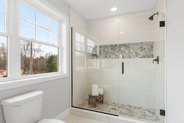 bathroom featuring a shower stall, marble finish floor, baseboards, toilet, and recessed lighting
