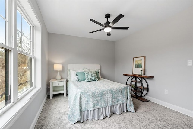 bedroom with ceiling fan, carpet floors, and baseboards
