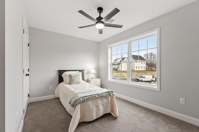 bedroom with visible vents, baseboards, carpet flooring, and ceiling fan