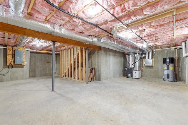 unfinished below grade area with heating unit, electric panel, and heat pump water heater