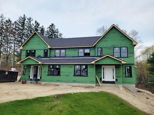 unfinished property with a shingled roof