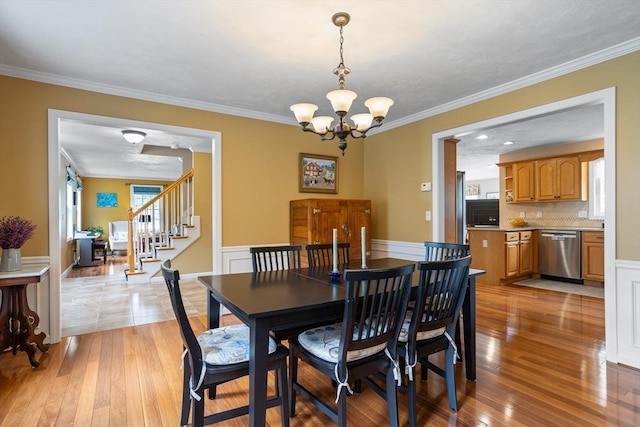 45 Taylor Rd, Maynard, MA 01754 - dining space featuring a chandelier, light wood finished floors, ornamental molding, and stairway