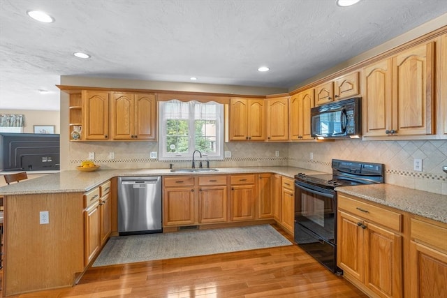 45 Taylor Rd, Maynard, MA 01754 - kitchen featuring black appliances, a sink, light wood finished floors, a peninsula, and recessed lighting