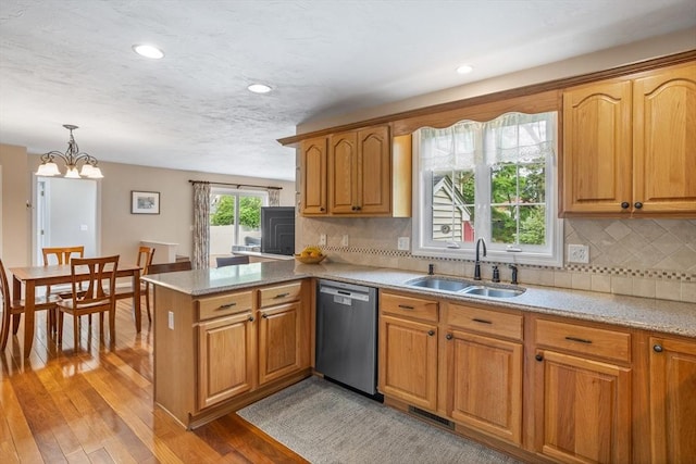 45 Taylor Rd, Maynard, MA 01754 - kitchen with dishwasher, a sink, a peninsula, light wood finished floors, and tasteful backsplash