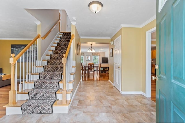 45 Taylor Rd, Maynard, MA 01754 - entryway with stairs, baseboards, crown molding, and a chandelier