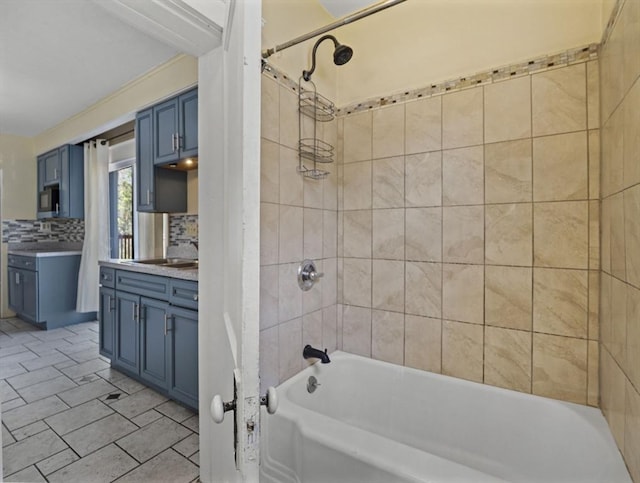 bathroom featuring shower / bath combination, vanity, tile patterned flooring, and backsplash