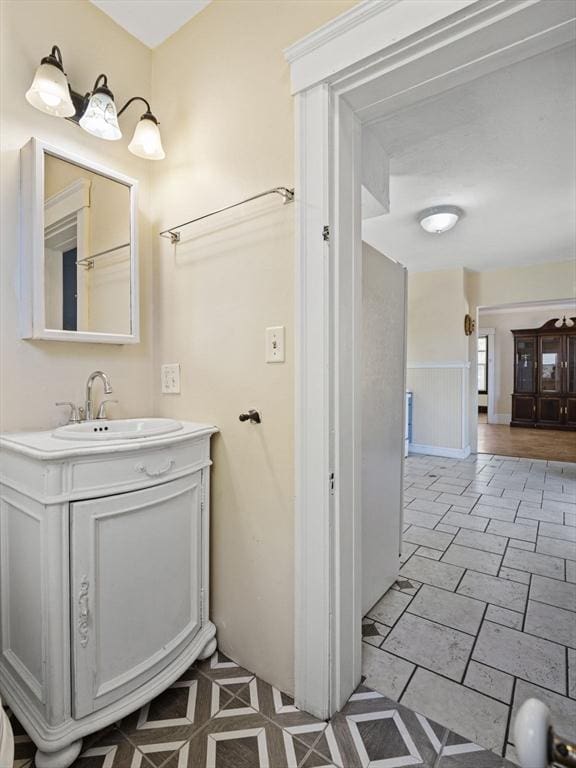 bathroom with vanity and wainscoting