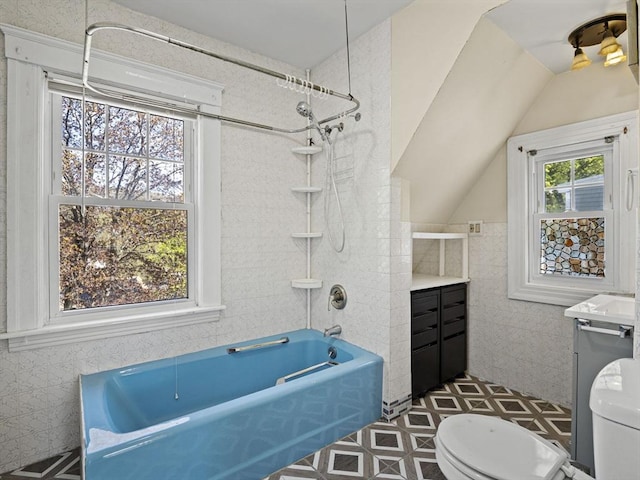 full bathroom with vanity, shower / washtub combination, toilet, and tile walls