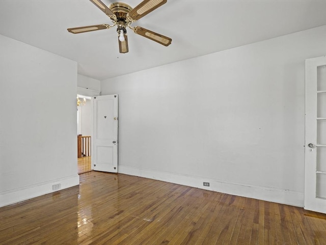 unfurnished room featuring baseboards, ceiling fan, and hardwood / wood-style floors