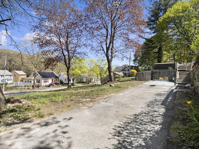 view of street with a residential view and aphalt driveway