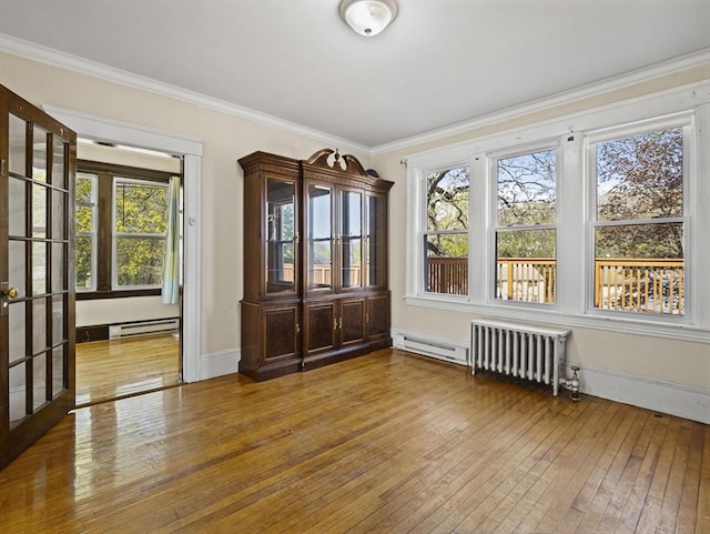 interior space featuring radiator heating unit, a baseboard radiator, and french doors