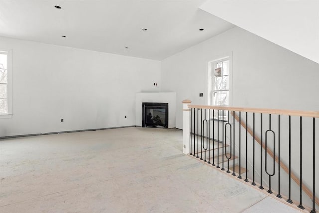 unfurnished living room with a glass covered fireplace