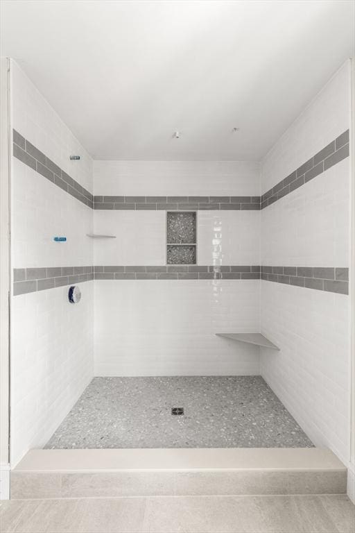 full bath with a tile shower