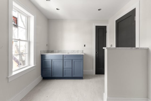 interior space with light countertops, a sink, and baseboards